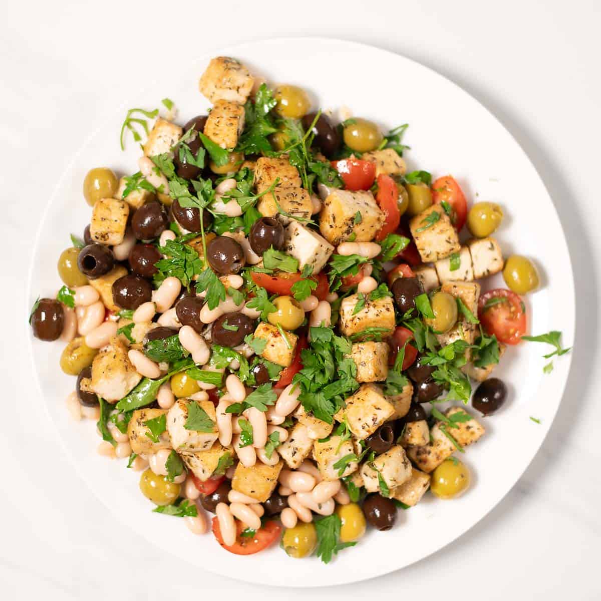 Top view of a serving of Olive Salad on a white plate.