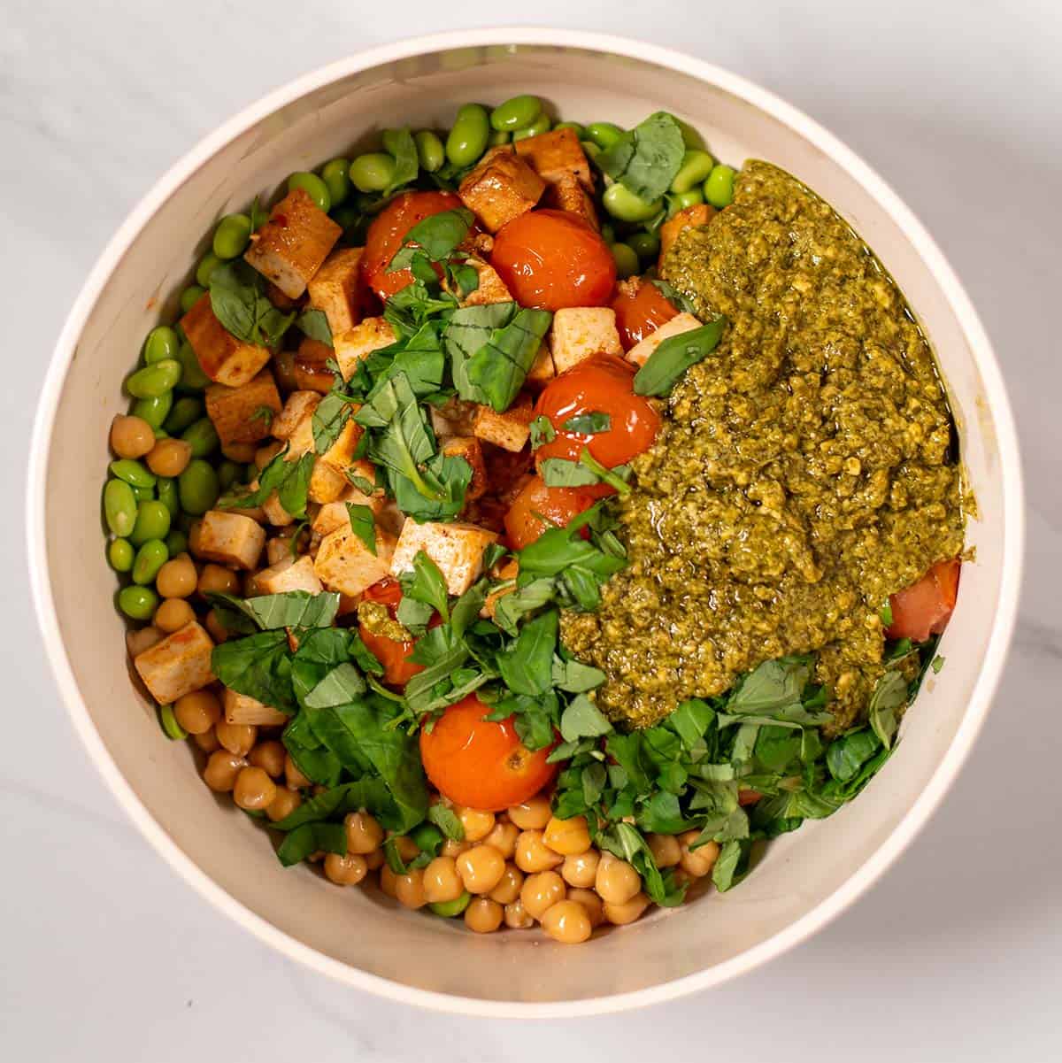 A large mixing bowl with the Pesto Chickpeas ingredients.