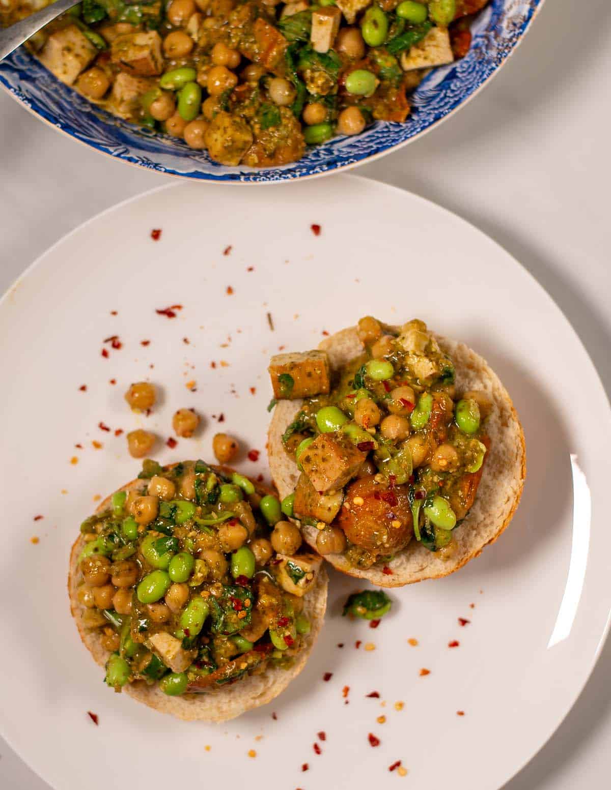 Pesto Chickpeas are spreak on toasted bread.