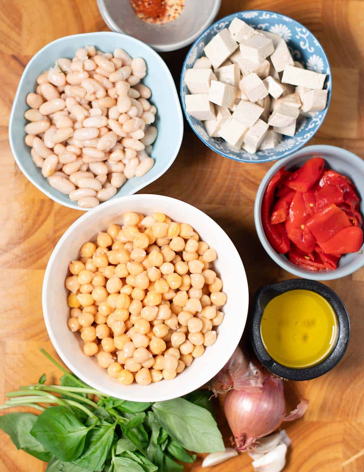 Ingredients needed to make Vegan Grinder Salad on a cutting board.