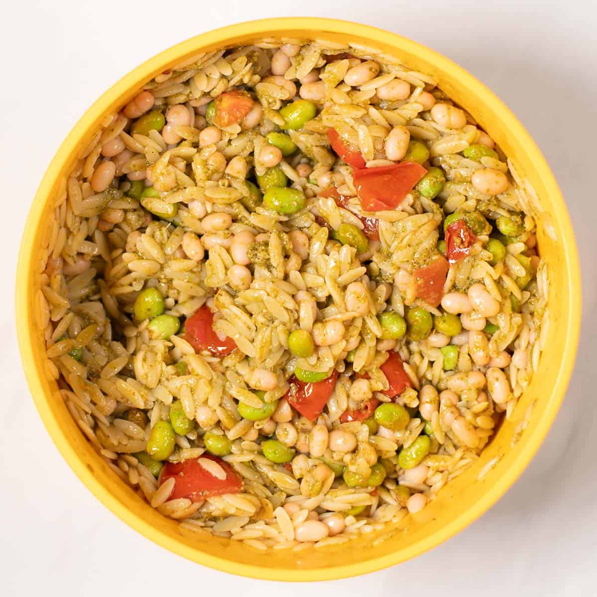Mixed Pesto Orzo in a mixing bowl.
