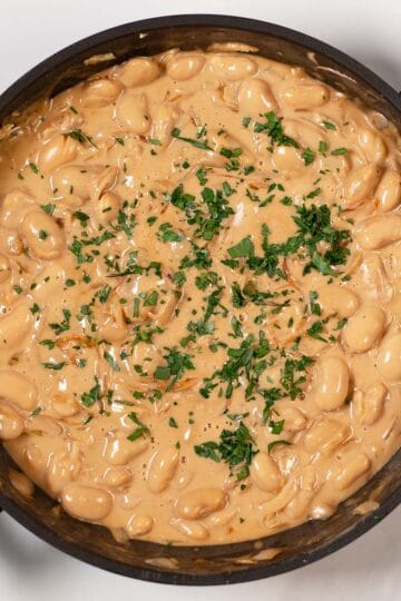 Fresh herbs used as garnish for French Onion Butter Beans.