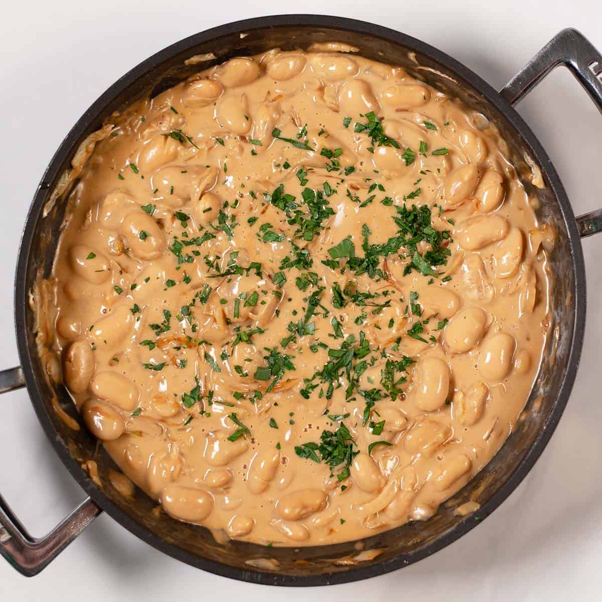 Fresh herbs used as garnish for French Onion Butter Beans.