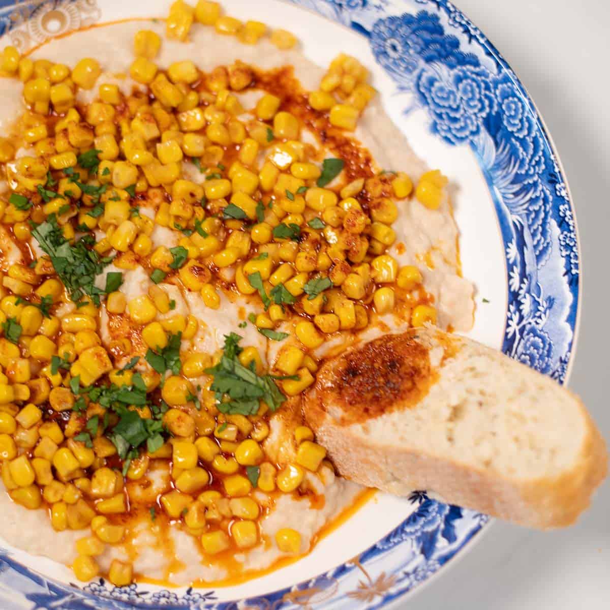 Closeup of bread with chili oil served with High Protein Corn Dip.