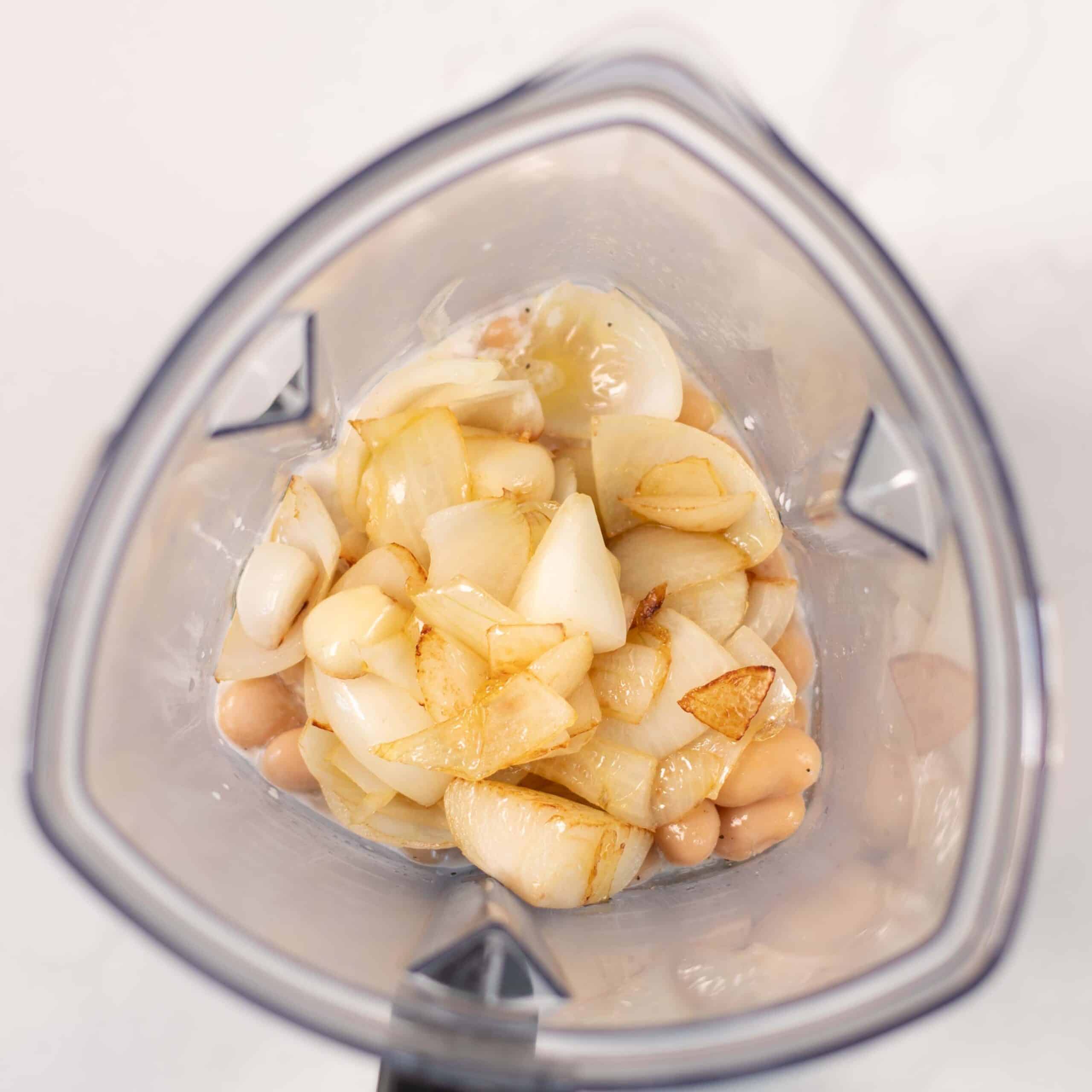 Sauce ingredients in the bowl of a blender.