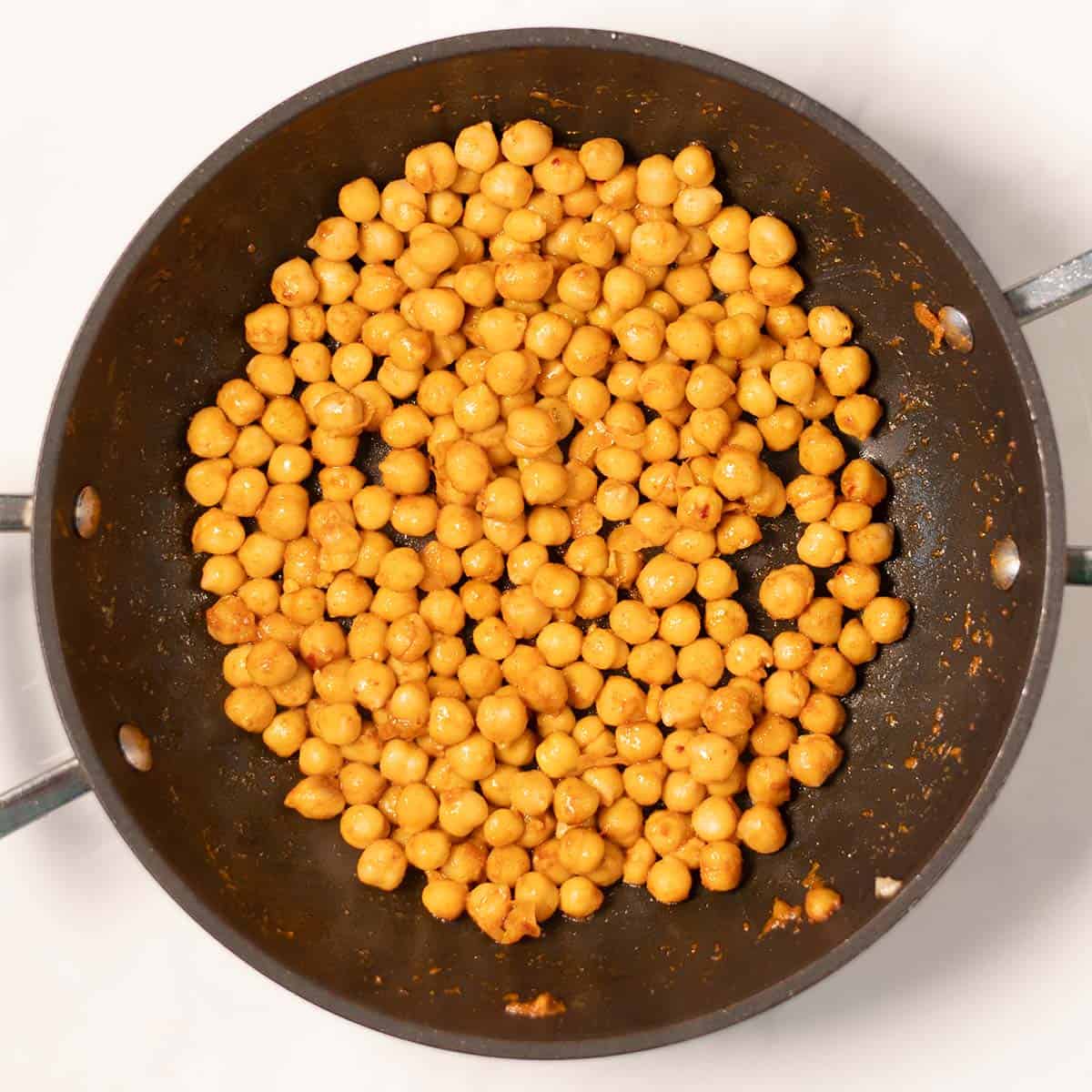 Toasted chickpeas in a pan.