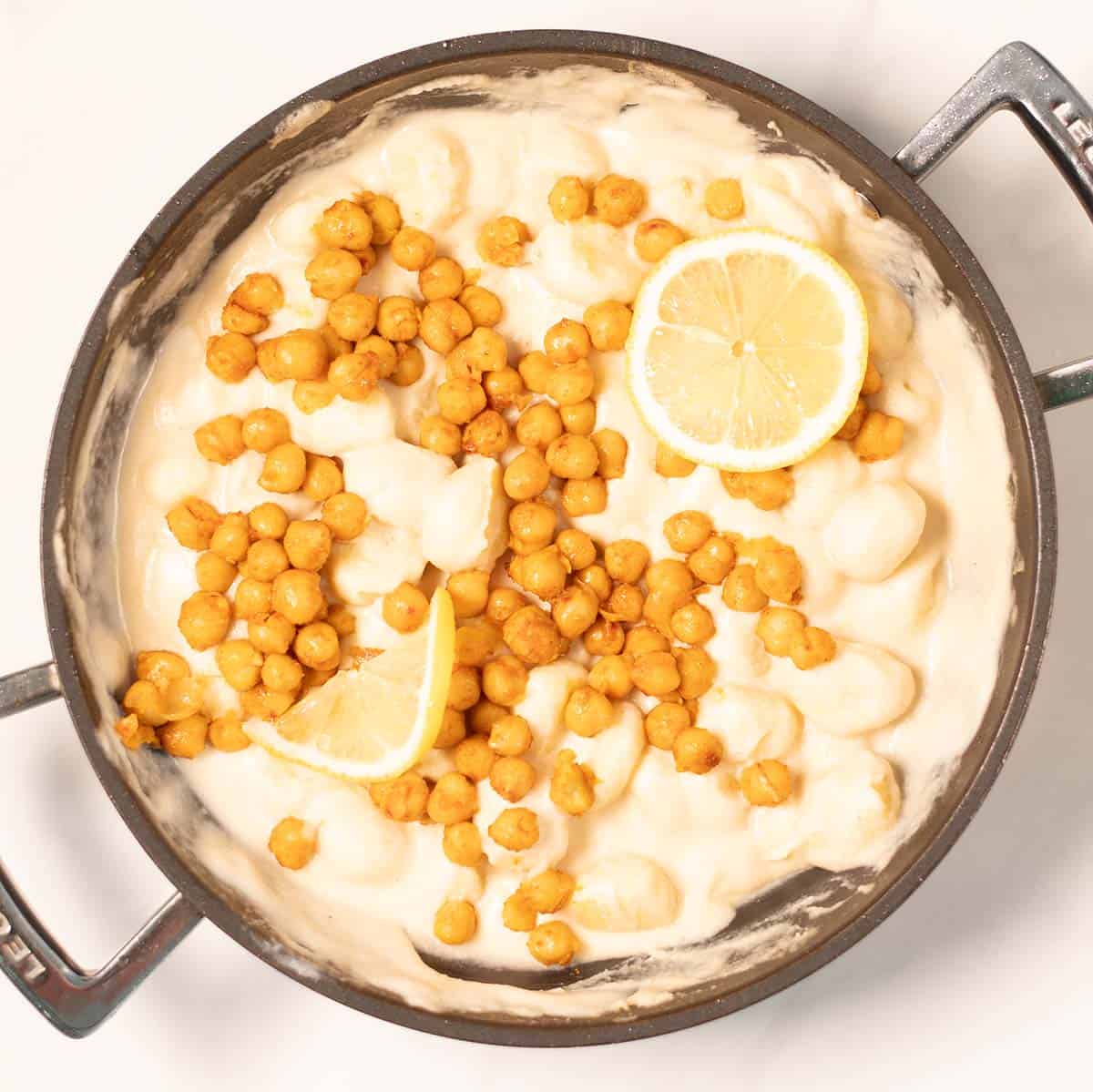 Toasted chickpeas top the Lemon Gnocchi, lemons are used as garnish.