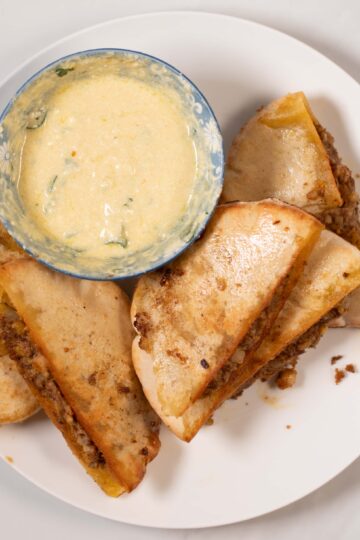 Vegan Arayes served on a plate with dipping sauce.