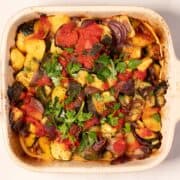 Briam as it comes out of the oven, garnished with fresh parsley.