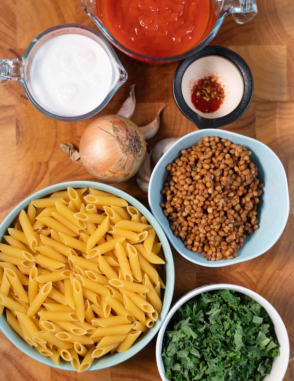 Ingredients needed to make Creamy Kale Pasta collected before preparation.