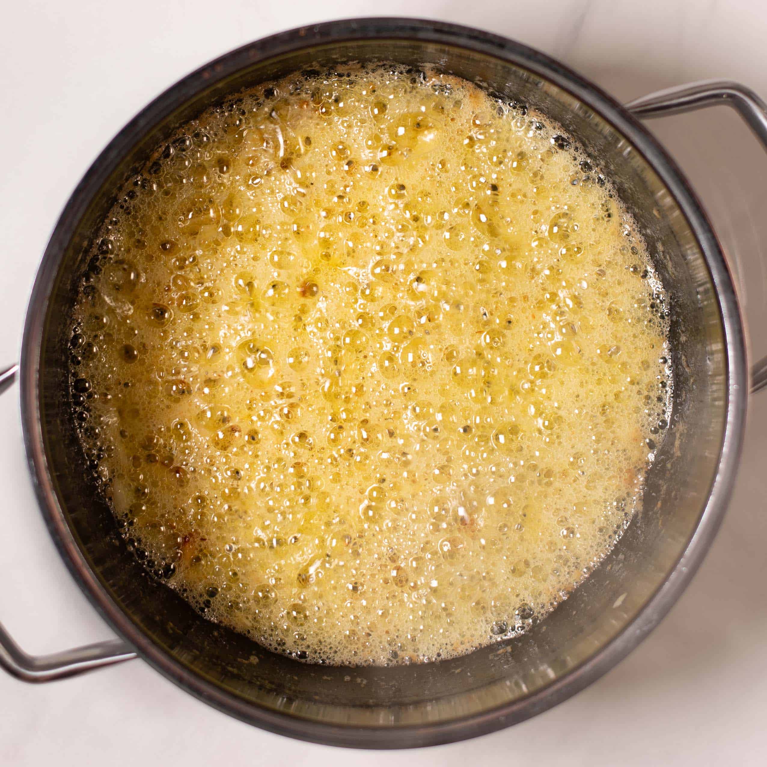 Onions are fried golden in a pan.