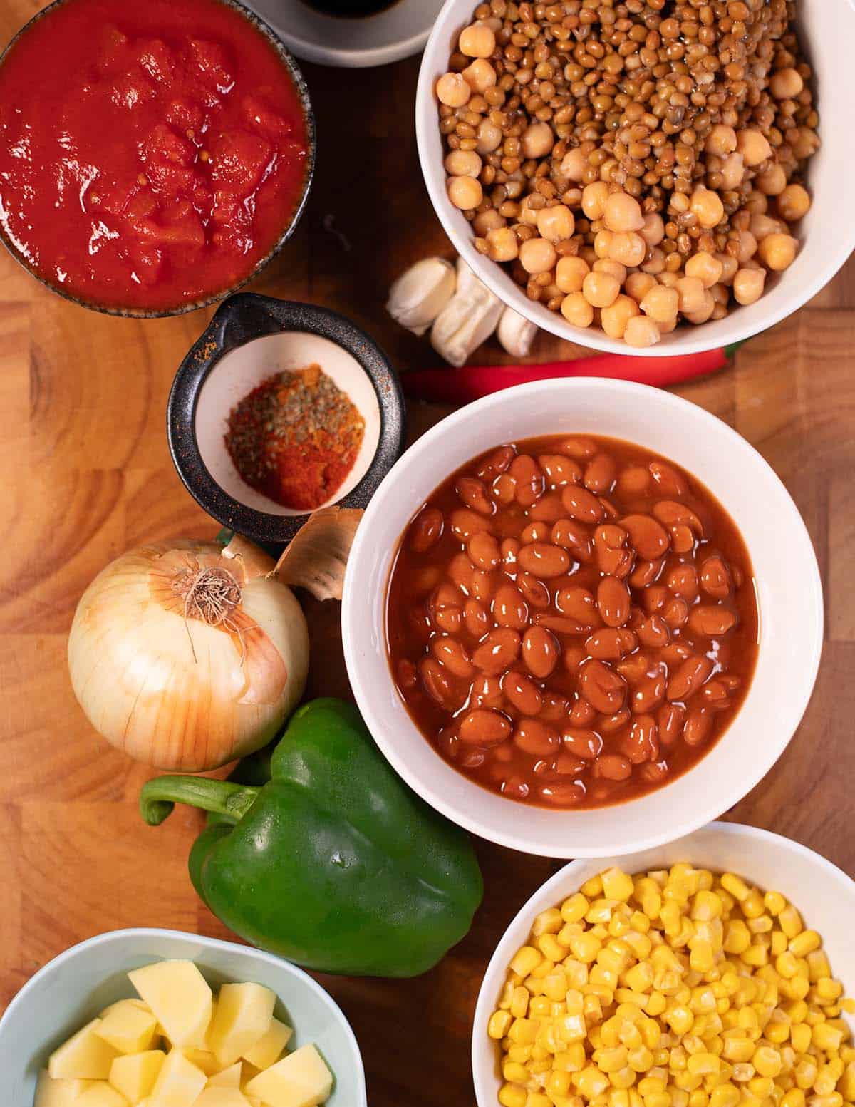 Ingredients needed to make Cowboy Soup on a wooden board.