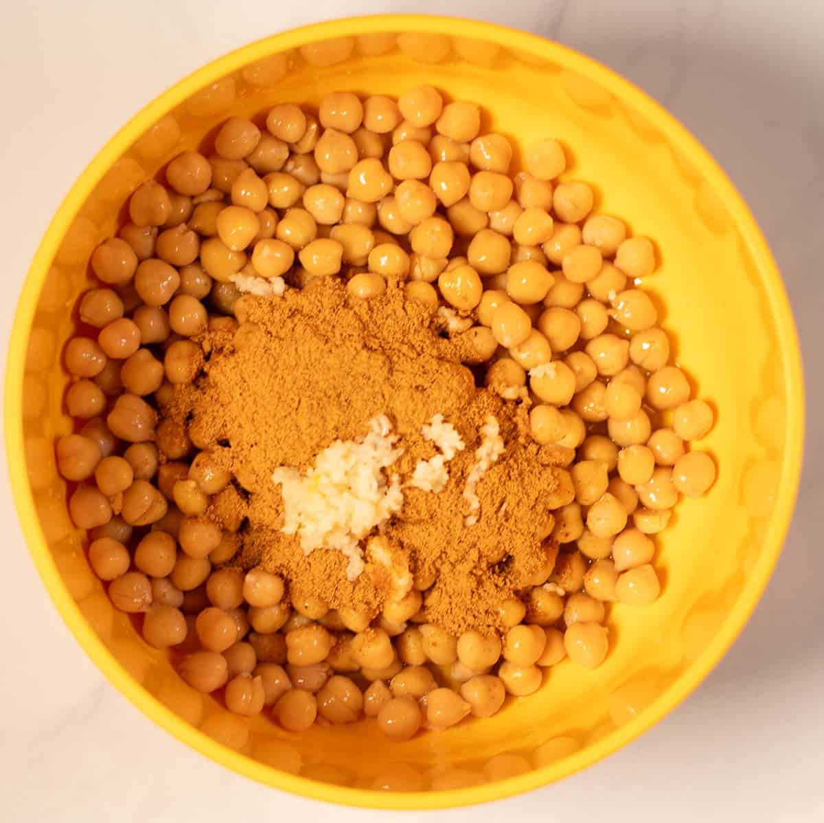 Chickpeas with shawarma spices in a yellow bowl for high-protein meal.