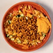 Vibrant chickpea shawarma bowl with vegetables and hummus.