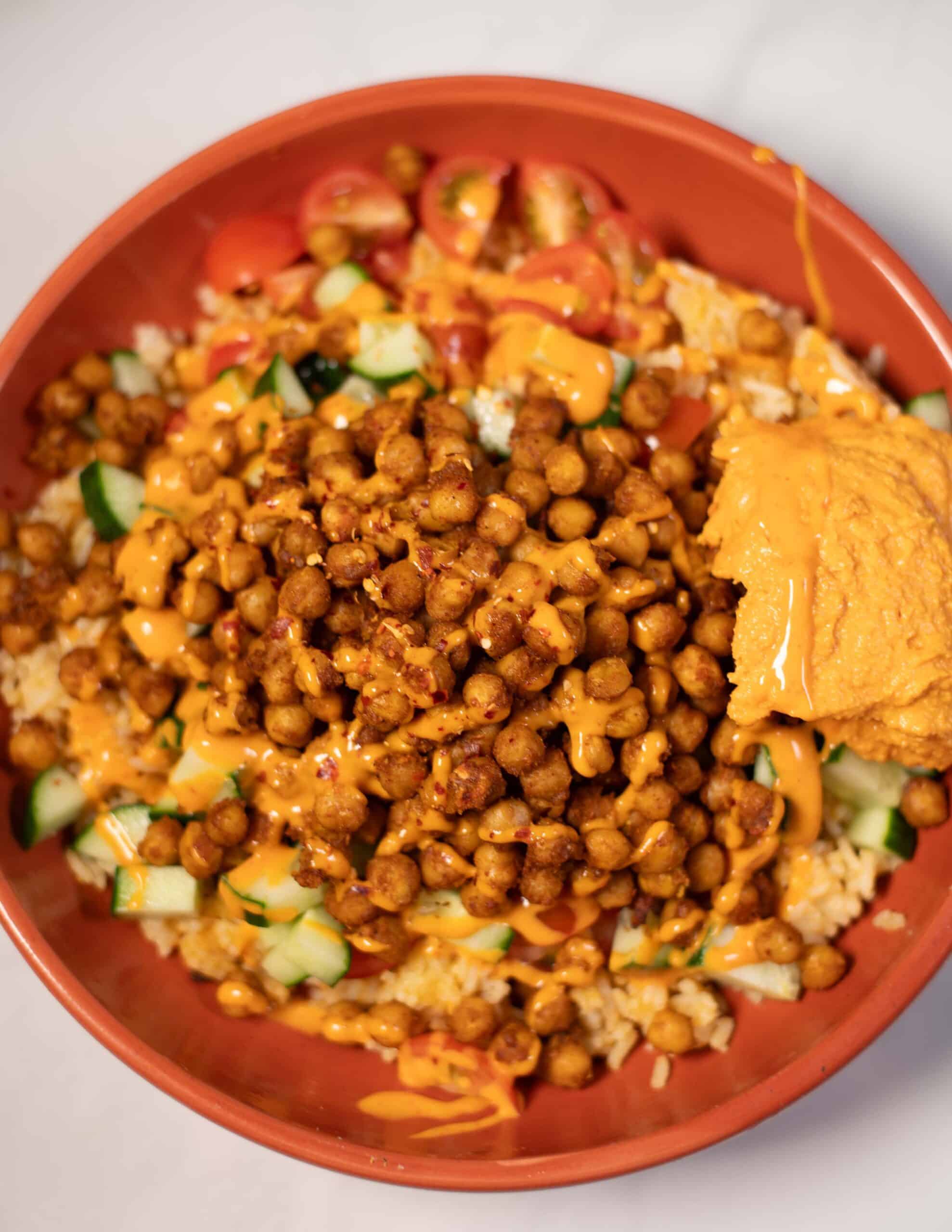 Vibrant chickpea shawarma bowl with vegetables and sauce in a bowl.