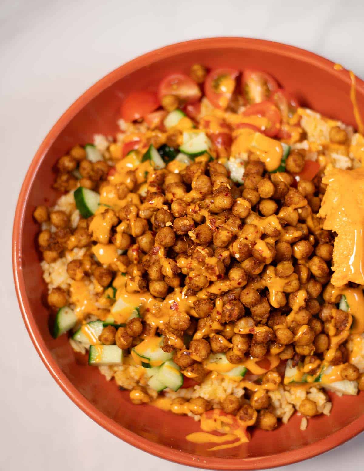 High-protein chickpea shawarma bowl with vegetables and sauce.