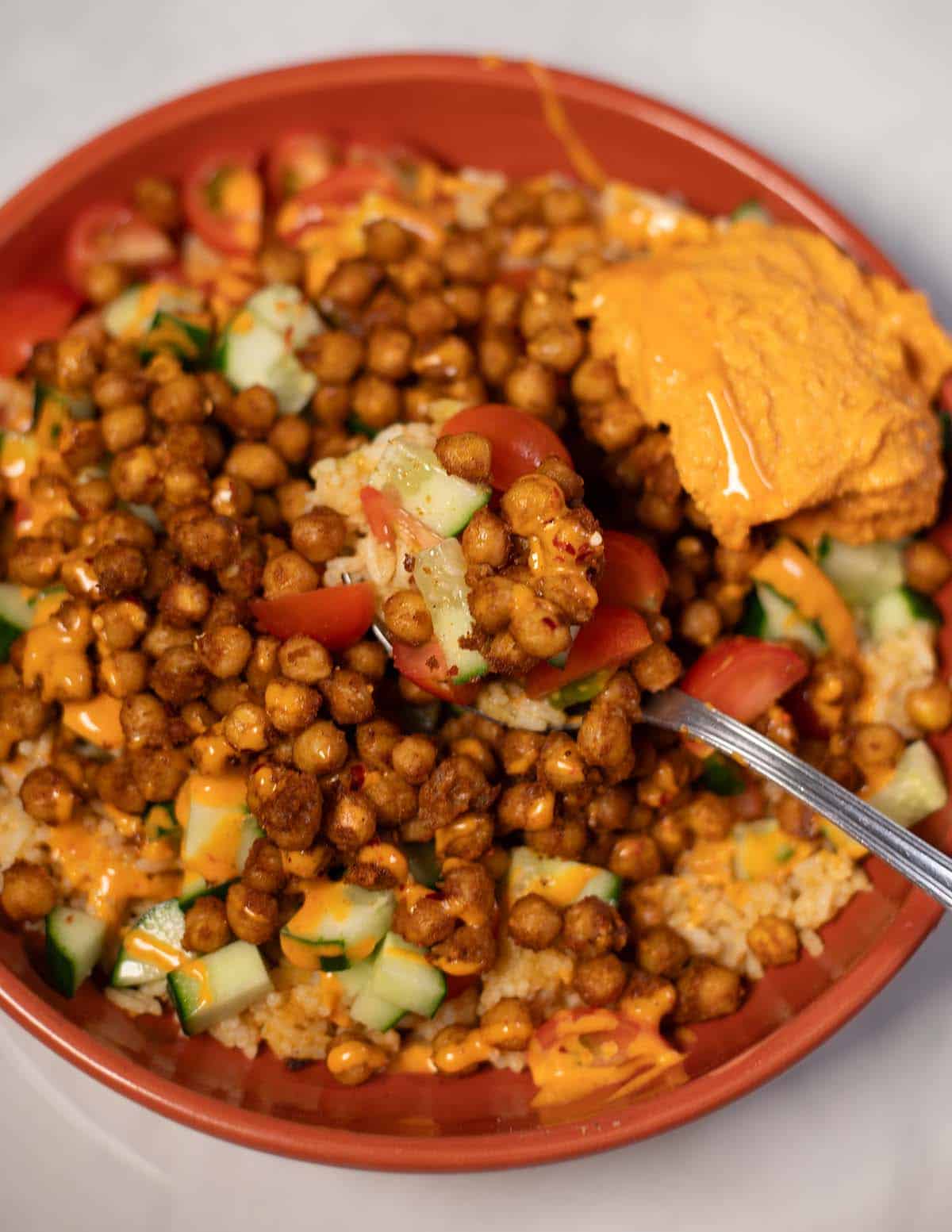 Vegan chickpea shawarma bowl with cucumber, tomato, and tahini sauce.