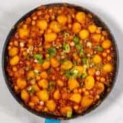 High-protein dirty potatoes with green onions in a skillet.