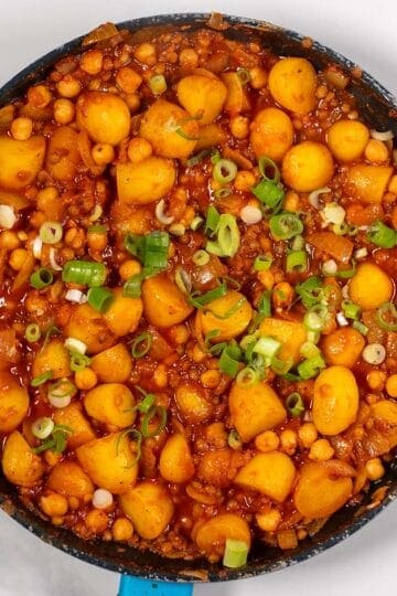 High-protein dirty potatoes with green onions in a skillet.