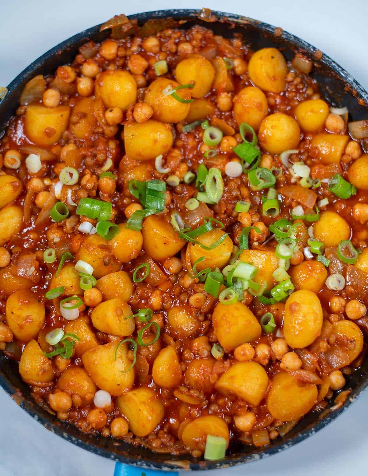 High-protein one-pan dirty potatoes with chickpeas and green onions.