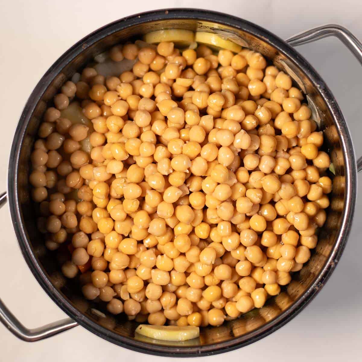 Close-up of cooked chickpeas in a pot for Greek chickpea soup.