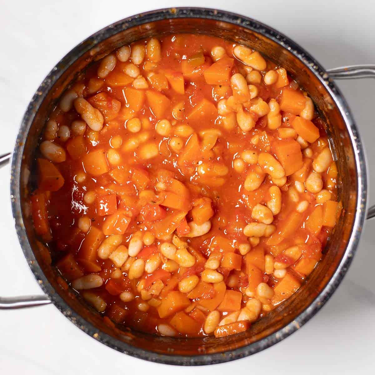 Close-up of sweet potato chili with white beans in a pot.